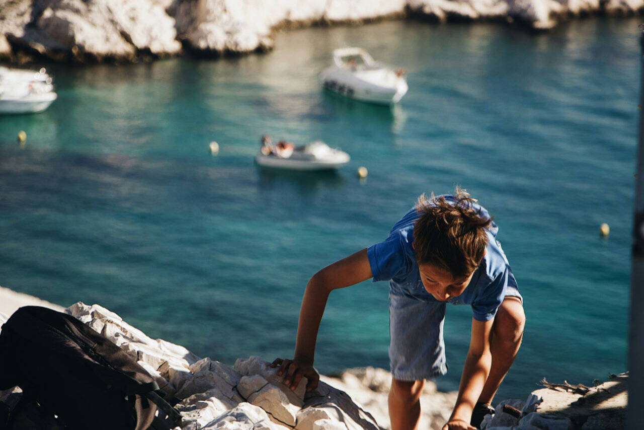 Climbing on the rock during sailing vacation in Istria and Kvarner